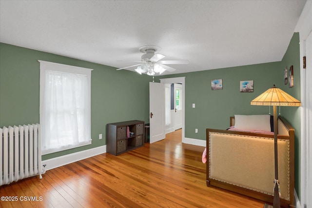288 Broadway St, Turbotville, PA 17772 - bedroom featuring radiator, wood finished floors, and baseboards