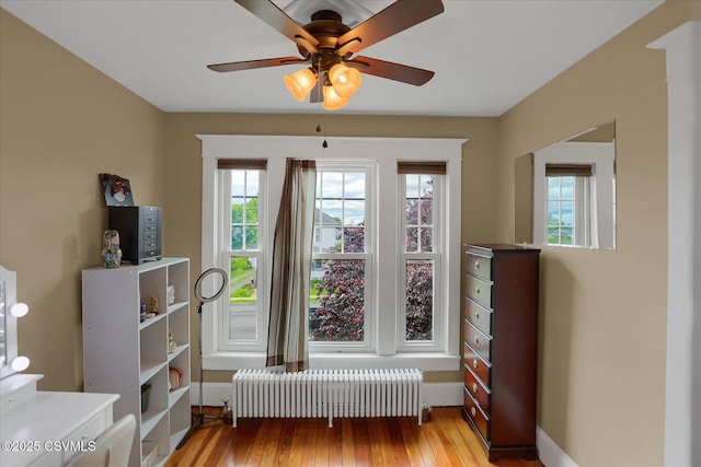 288 Broadway St, Turbotville, PA 17772 - interior space featuring radiator, a ceiling fan, hardwood / wood-style floors, and baseboards
