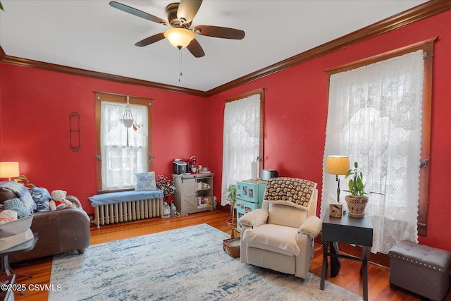 288 Broadway St, Turbotville, PA 17772 - living area with ceiling fan, wood finished floors, ornamental molding, and radiator