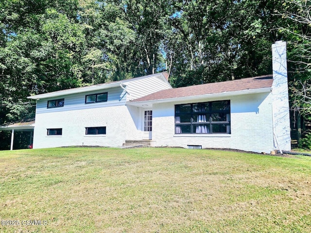 43 Red Oak Dr, Danville, PA 17821 - tri-level home with brick siding, a front yard, and a chimney