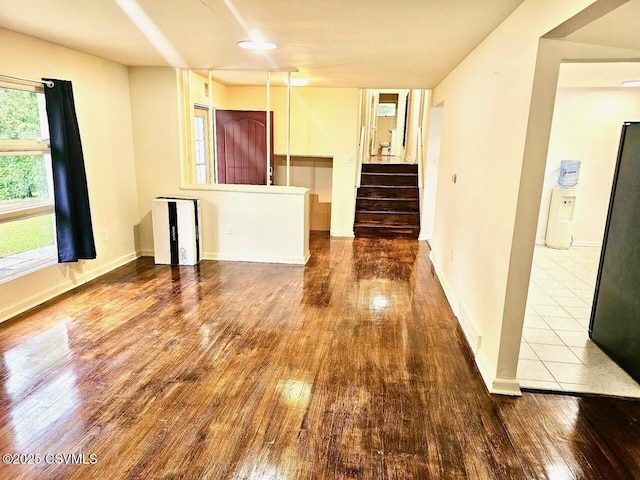 43 Red Oak Dr, Danville, PA 17821 - unfurnished living room featuring wood-type flooring, stairway, and baseboards