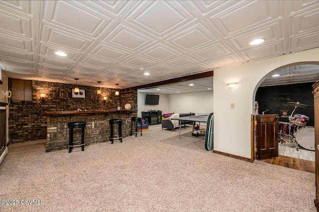 937 E 10th St, Berwick, PA 18603 - indoor dry bar with carpet floors, an ornate ceiling, baseboards, brick wall, and arched walkways