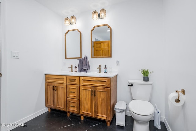 937 E 10th St, Berwick, PA 18603 - full bath with double vanity, toilet, baseboards, and marble finish flooring