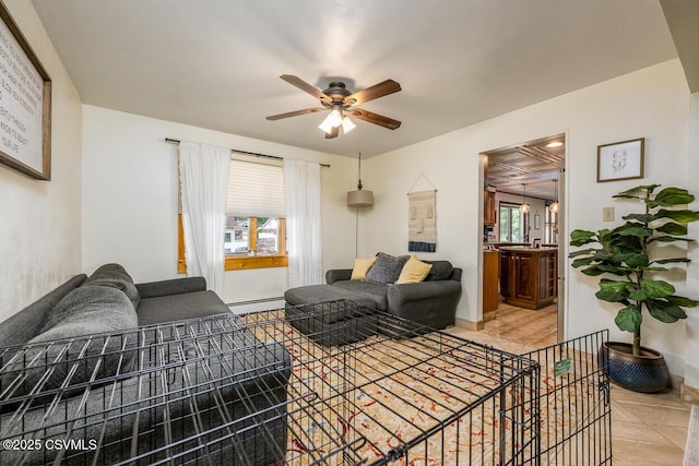 937 E 10th St, Berwick, PA 18603 - living area featuring ceiling fan, plenty of natural light, a baseboard radiator, and baseboards