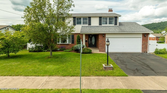 937 E 10th St, Berwick, PA 18603 - traditional home featuring a chimney, asphalt driveway, brick siding, and a garage