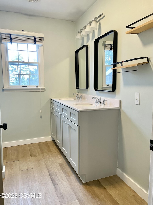 3014 Smoketown Rd, Lewisburg, PA 17837 - full bathroom featuring wood finished floors, double vanity, and baseboards