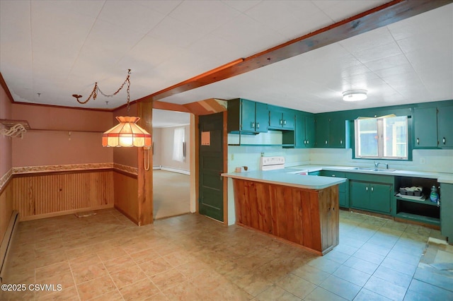 205 N Water St, Selinsgrove, PA 17870 - kitchen featuring stove, light countertops, green cabinets, a sink, and wainscoting
