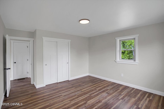 2196 Continental Blvd, Danville, PA 17821 - unfurnished bedroom featuring dark wood-style flooring, baseboards, and a closet