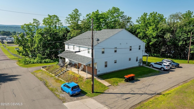 1597 N Mulberry St, Berwick, PA 18603 - view of home's exterior with roof with shingles, a yard, and uncovered parking