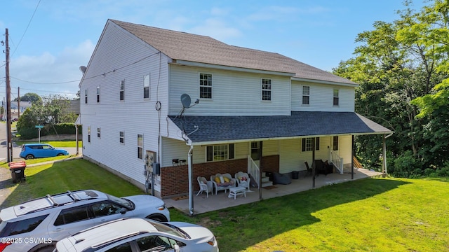 1597 N Mulberry St, Berwick, PA 18603 - rear view of house with a yard, a shingled roof, brick siding, an outdoor living space, and a patio