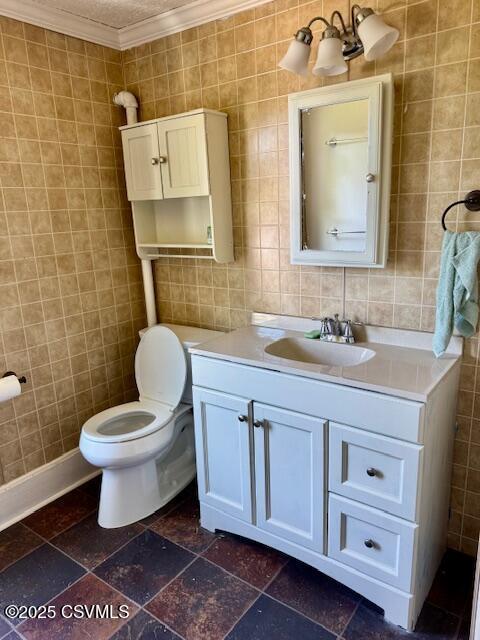 833 Line St, Sunbury, PA 17801 - half bath featuring tile walls, vanity, crown molding, and toilet