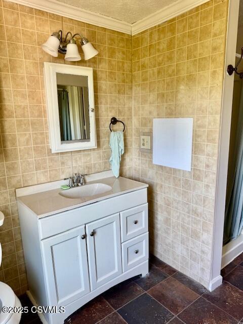 833 Line St, Sunbury, PA 17801 - bathroom with tile walls, vanity, toilet, and crown molding