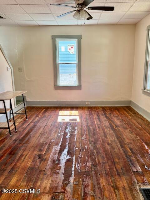 833 Line St, Sunbury, PA 17801 - empty room with ceiling fan, hardwood / wood-style flooring, a drop ceiling, baseboards, and plenty of natural light