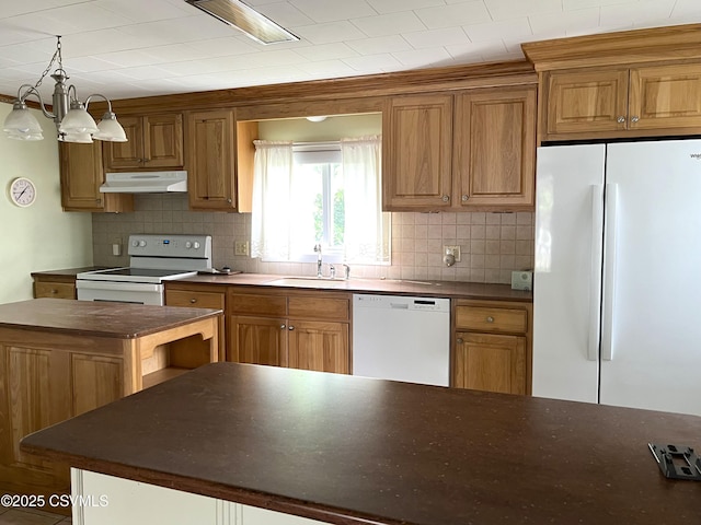 433 E 6th St, Berwick, PA 18603 - kitchen featuring white appliances, under cabinet range hood, a sink, dark countertops, and backsplash