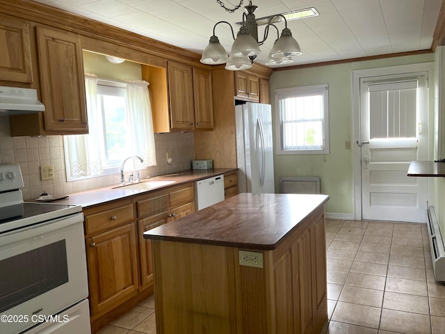433 E 6th St, Berwick, PA 18603 - kitchen with white appliances, a sink, under cabinet range hood, brown cabinetry, and crown molding