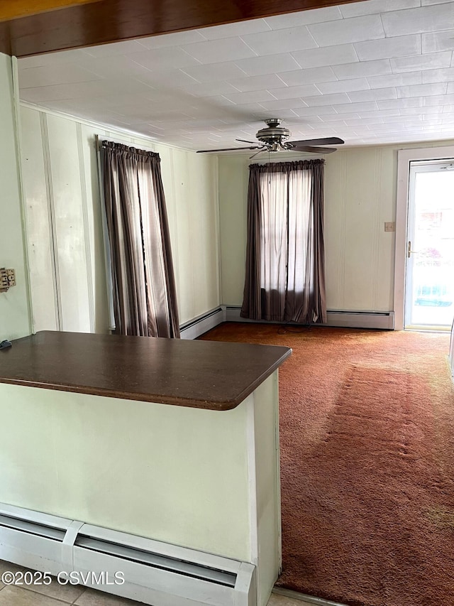 433 E 6th St, Berwick, PA 18603 - kitchen featuring carpet flooring, dark countertops, ceiling fan, and a baseboard radiator