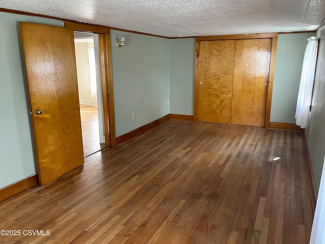 433 E 6th St, Berwick, PA 18603 - unfurnished bedroom featuring hardwood / wood-style flooring, crown molding, baseboards, and a closet