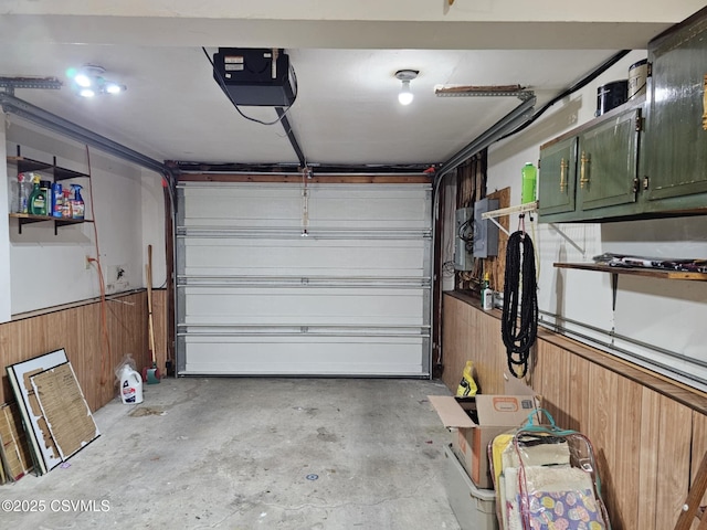 1605 W Montgomery St, Coal Township, PA 17866 - garage featuring a garage door opener, wood walls, and wainscoting