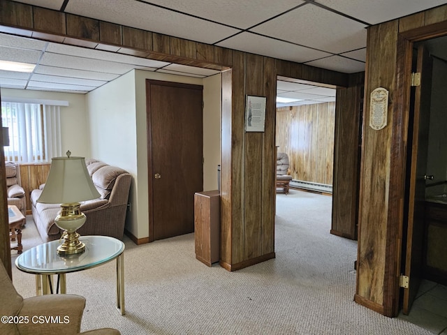 1605 W Montgomery St, Coal Township, PA 17866 - hall with a paneled ceiling, wooden walls, light colored carpet, baseboards, and a baseboard heating unit