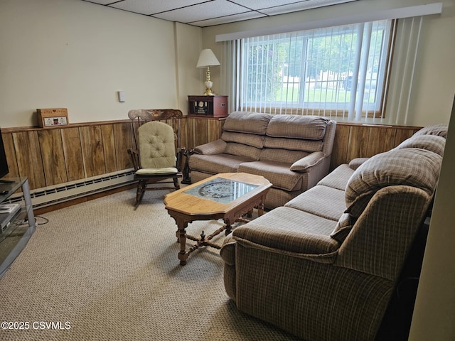 1605 W Montgomery St, Coal Township, PA 17866 - carpeted living area featuring a drop ceiling, wainscoting, a baseboard radiator, and wood walls