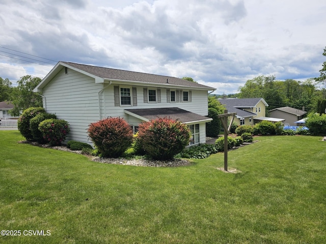 1605 W Montgomery St, Coal Township, PA 17866 - rear view of property featuring a lawn and roof with shingles