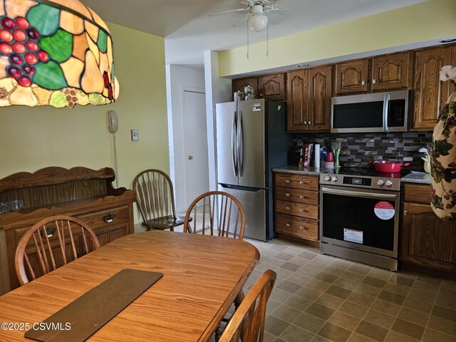 1605 W Montgomery St, Coal Township, PA 17866 - kitchen featuring appliances with stainless steel finishes, decorative backsplash, ceiling fan, and dark brown cabinetry