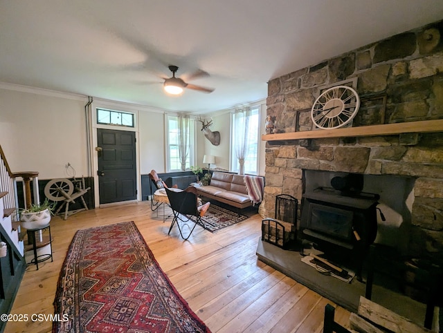 2852 State Route 487, Orangeville, PA 17859 - living area featuring a wood stove, a ceiling fan, hardwood / wood-style floors, ornamental molding, and stairway