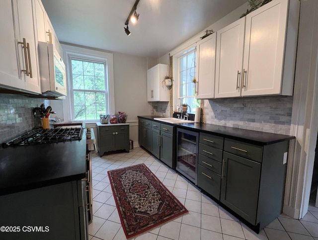 2852 State Route 487, Orangeville, PA 17859 - kitchen featuring wine cooler, white microwave, white cabinets, backsplash, and dark countertops