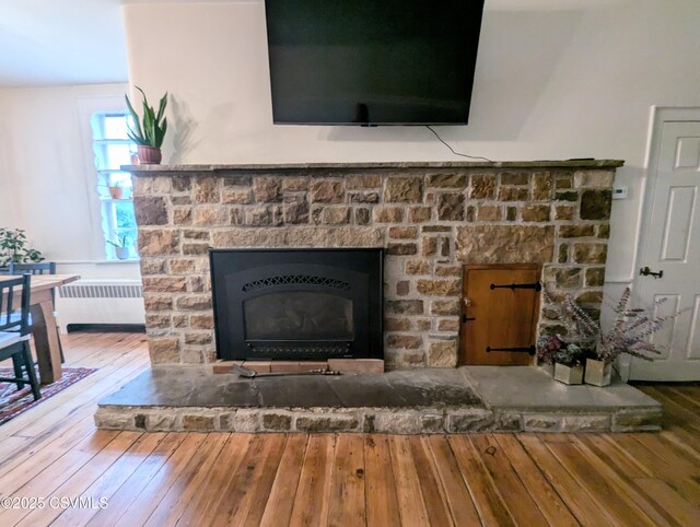 2852 State Route 487, Orangeville, PA 17859 - detailed view of radiator heating unit, a fireplace with raised hearth, and wood finished floors