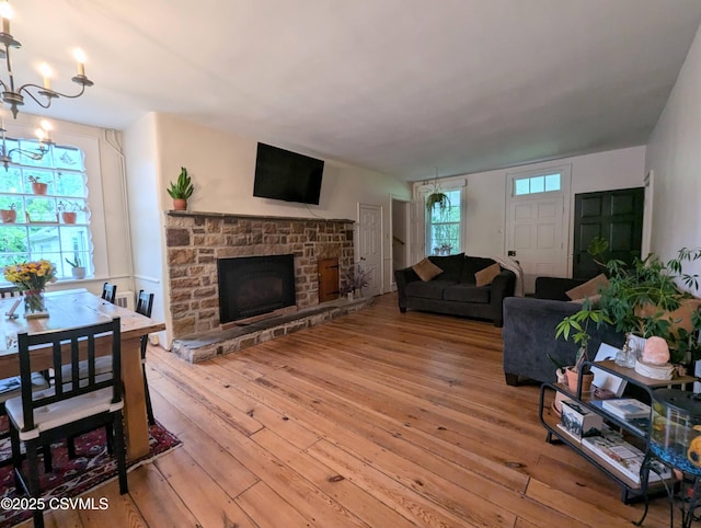 2852 State Route 487, Orangeville, PA 17859 - living area featuring light wood-style floors, a fireplace with raised hearth, and a chandelier