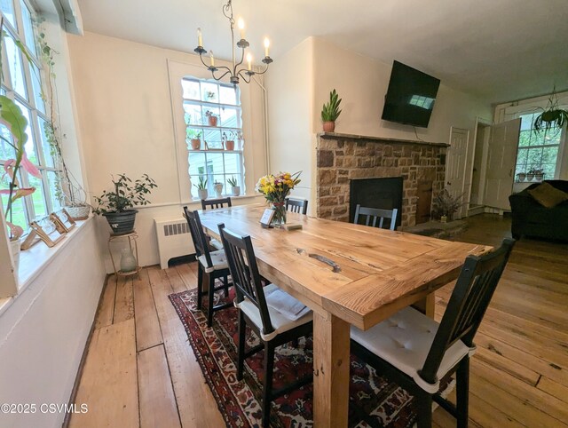 2852 State Route 487, Orangeville, PA 17859 - dining space with light wood finished floors, a chandelier, and radiator heating unit