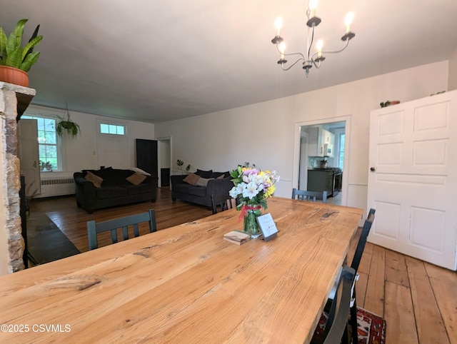 2852 State Route 487, Orangeville, PA 17859 - dining room featuring radiator heating unit, a chandelier, and wood-type flooring