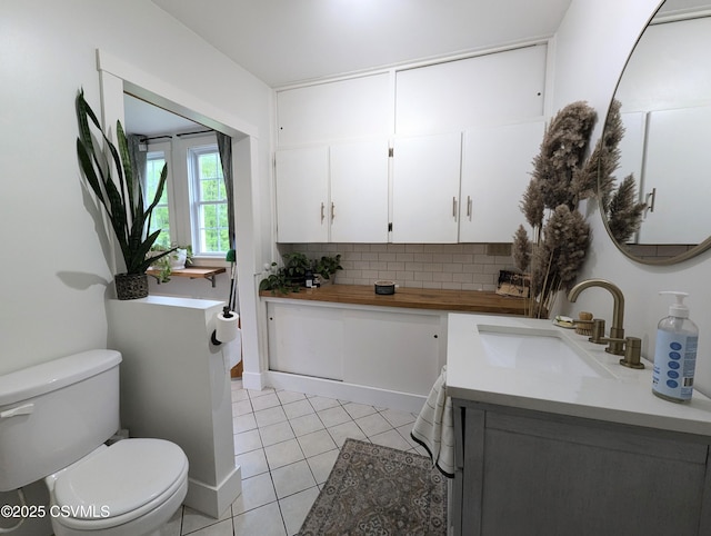 2852 State Route 487, Orangeville, PA 17859 - bathroom with toilet, vanity, tasteful backsplash, and tile patterned flooring