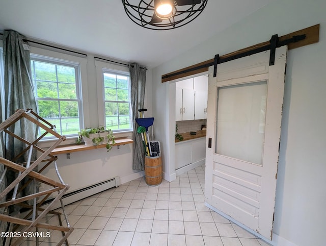 2852 State Route 487, Orangeville, PA 17859 - dining room featuring a barn door, light tile patterned floors, and baseboards