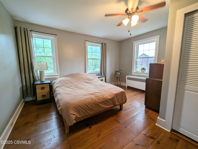 2852 State Route 487, Orangeville, PA 17859 - bedroom with radiator, multiple windows, hardwood / wood-style flooring, and baseboards