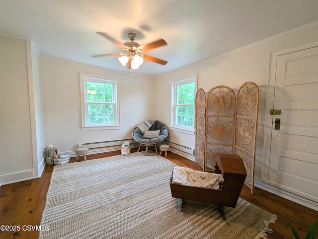 2852 State Route 487, Orangeville, PA 17859 - living area with a baseboard radiator, a ceiling fan, ornamental molding, hardwood / wood-style flooring, and baseboards