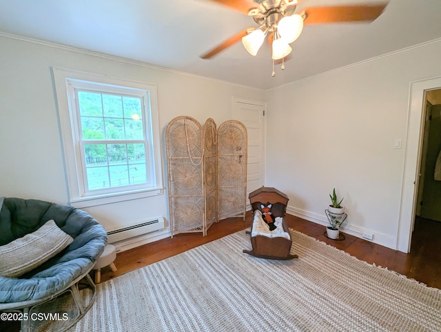 2852 State Route 487, Orangeville, PA 17859 - living area featuring baseboard heating, wood finished floors, ceiling fan, baseboards, and crown molding