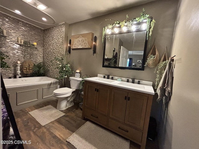220 Spring Lake Crst, Watsontown, PA 17777 - bathroom featuring wood finished floors, double vanity, a bath, toilet, and recessed lighting