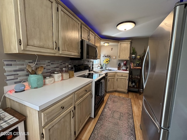 220 Spring Lake Crst, Watsontown, PA 17777 - kitchen with appliances with stainless steel finishes, light wood-style flooring, backsplash, light countertops, and light brown cabinets