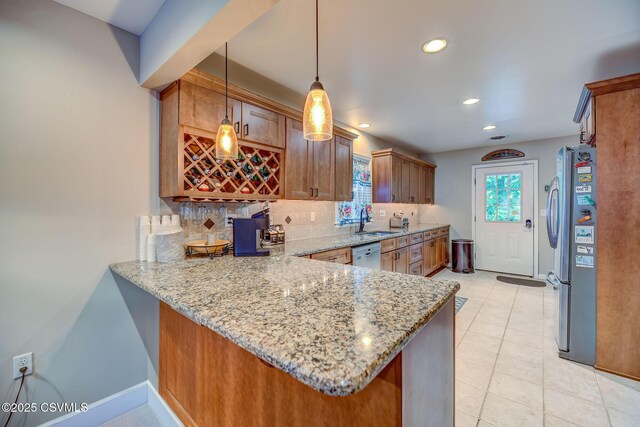 475 W 1st St, Bloomsburg, PA 17815 - kitchen featuring freestanding refrigerator, a sink, backsplash, white dishwasher, and light stone countertops