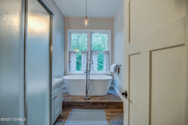 475 W 1st St, Bloomsburg, PA 17815 - bathroom featuring a freestanding tub, vanity, and wood finished floors