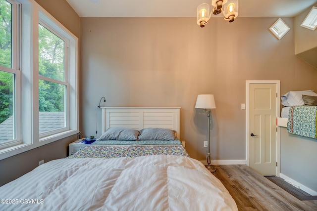 475 W 1st St, Bloomsburg, PA 17815 - bedroom featuring wood finished floors, a chandelier, and baseboards