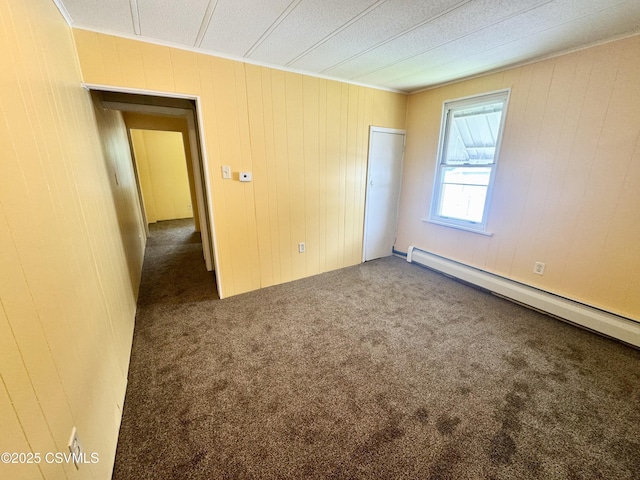 338 W Saylor St, Atlas, PA 17851 - unfurnished bedroom with a baseboard radiator, carpet flooring, wooden walls, a closet, and ornamental molding
