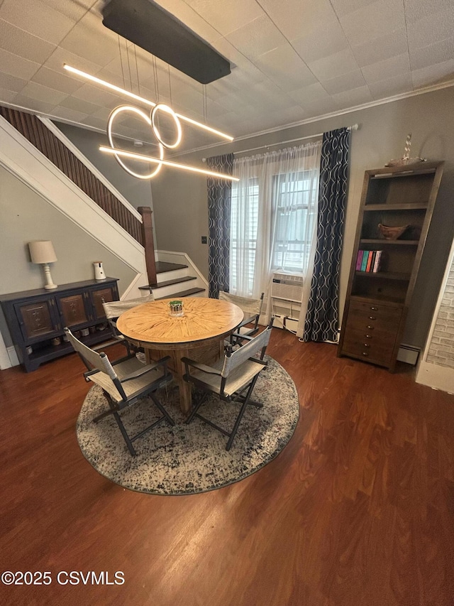 1644 W Walnut St, Coal Township, PA 17866 - dining room with stairway, baseboard heating, wood finished floors, a chandelier, and crown molding
