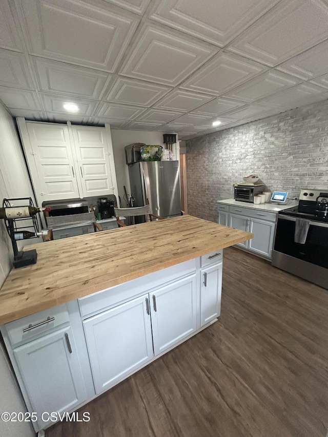 1644 W Walnut St, Coal Township, PA 17866 - kitchen with wooden counters, appliances with stainless steel finishes, an ornate ceiling, dark wood-style floors, and white cabinetry