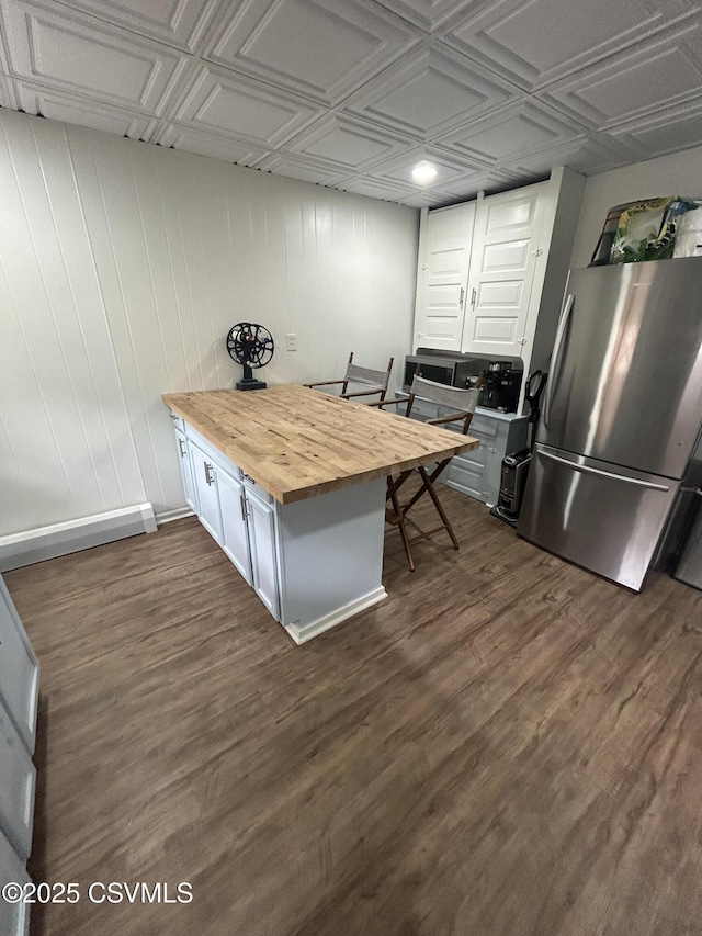 1644 W Walnut St, Coal Township, PA 17866 - kitchen featuring wooden counters, freestanding refrigerator, an ornate ceiling, dark wood-style flooring, and wood walls