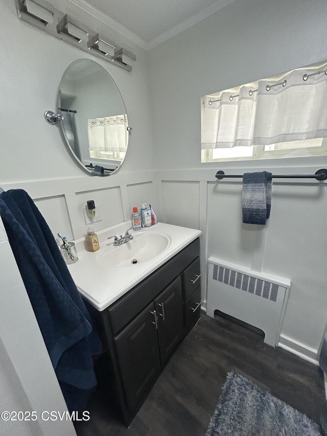 1644 W Walnut St, Coal Township, PA 17866 - bathroom featuring radiator heating unit, crown molding, vanity, wood finished floors, and wainscoting