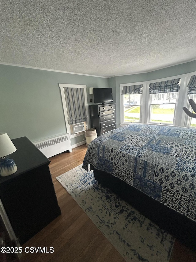 1644 W Walnut St, Coal Township, PA 17866 - bedroom featuring radiator heating unit, wood finished floors, and a textured ceiling