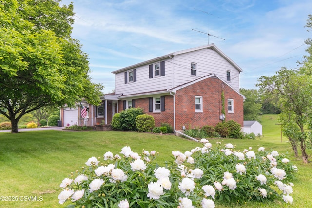 2256 Crossroads Dr, Lewisburg, PA 17837 - traditional-style house with brick siding, an attached garage, and a front yard