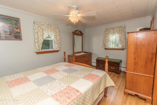 2256 Crossroads Dr, Lewisburg, PA 17837 - bedroom with light wood-style floors, a baseboard heating unit, crown molding, and a ceiling fan